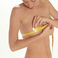 Woman measuring her breasts