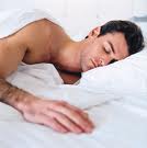 Man sleeping in white sheets