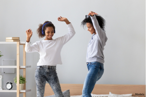 Slim mom dancing with daughter