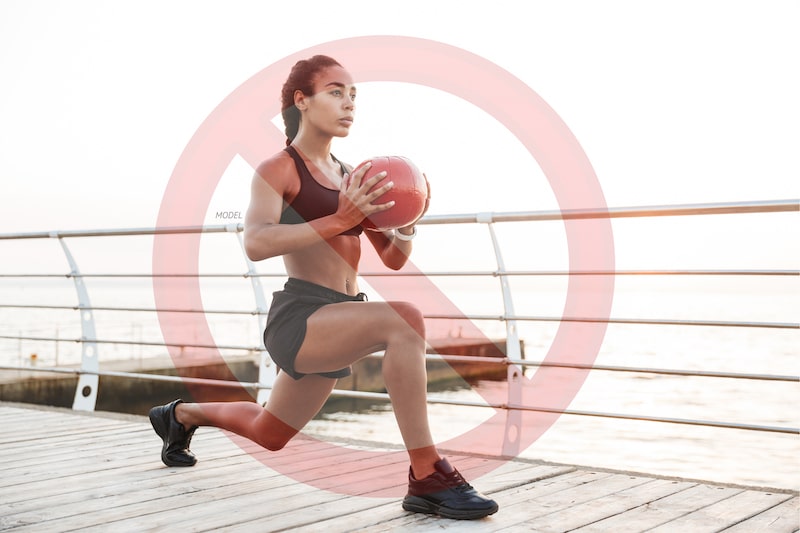 Woman doing a lunge with a warning sign on top.