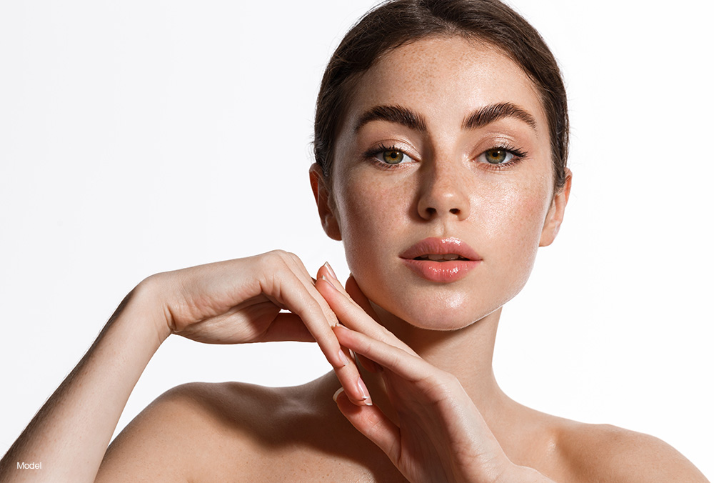 Young woman with her hands under her chin