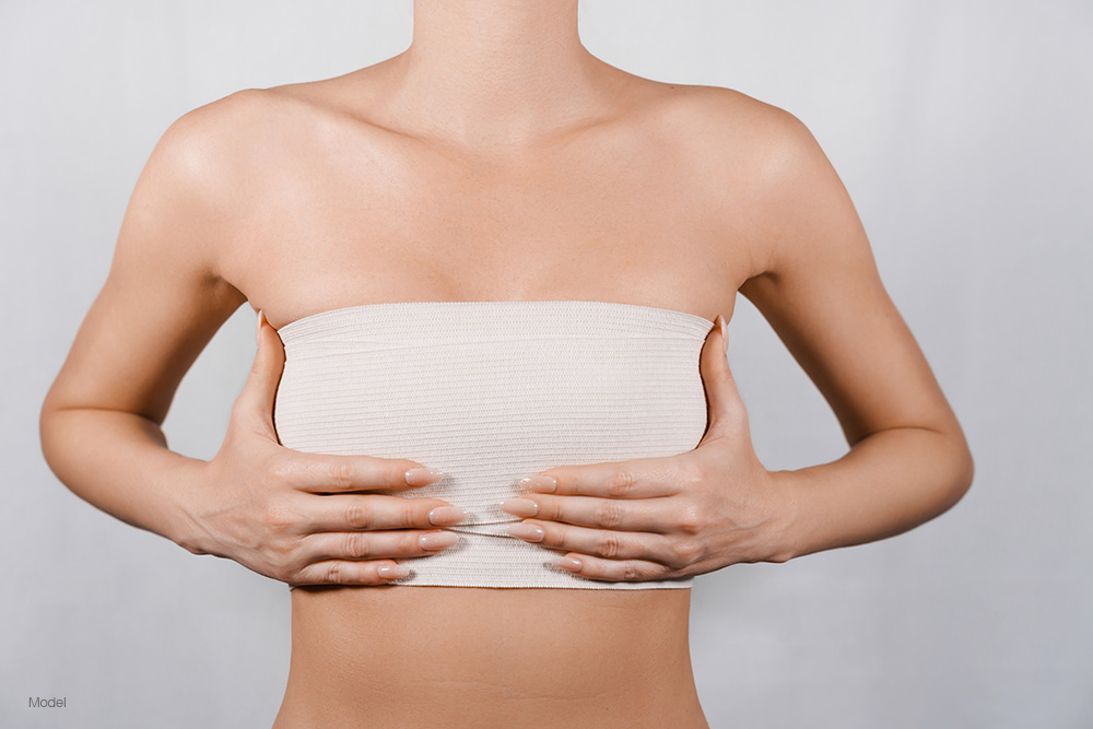 woman with bandages over her breasts